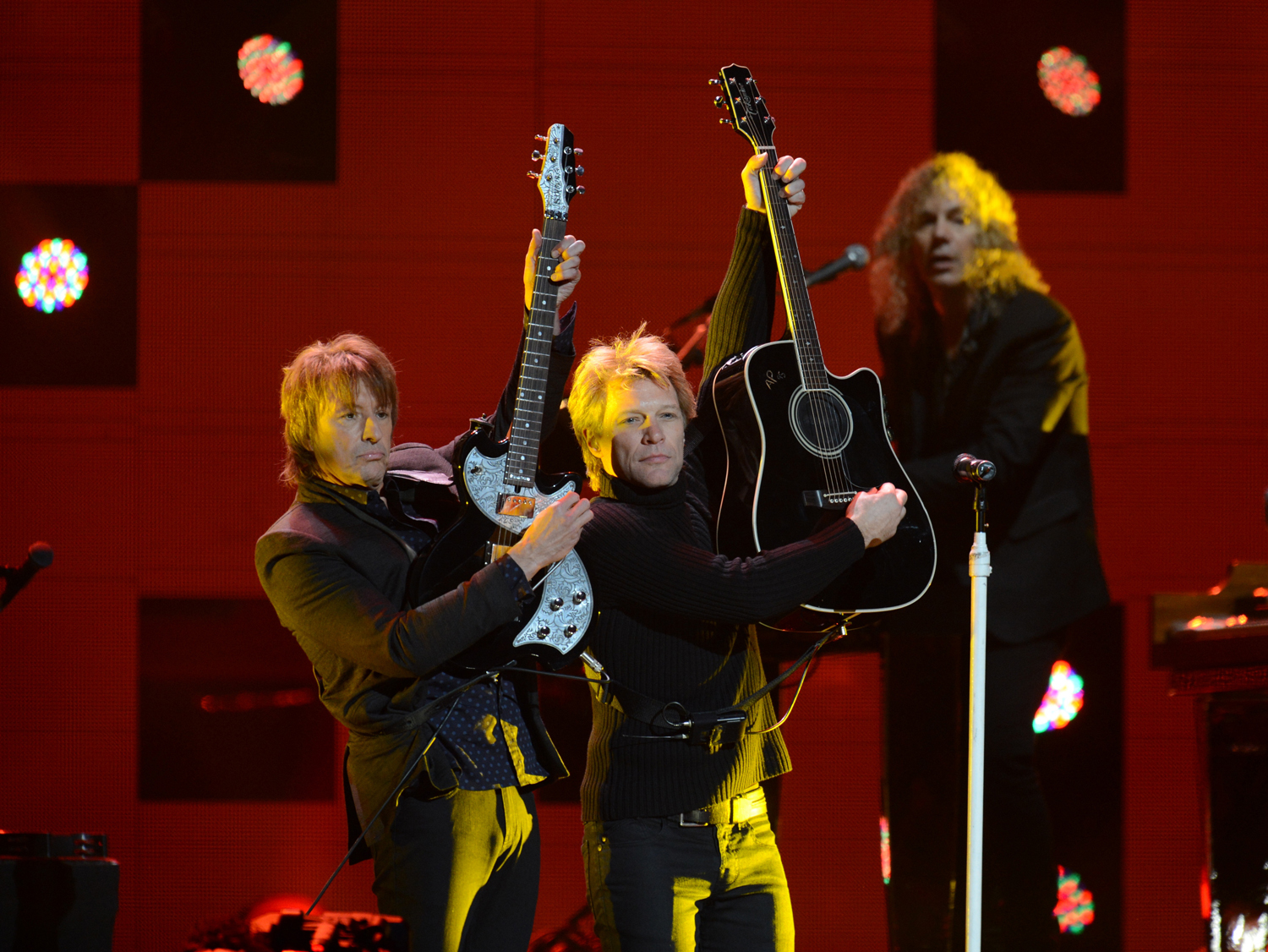 Jon Bon Jovi (R) performs during "12-12-12" a concert benefiting the victims of Hurricane Sandy
