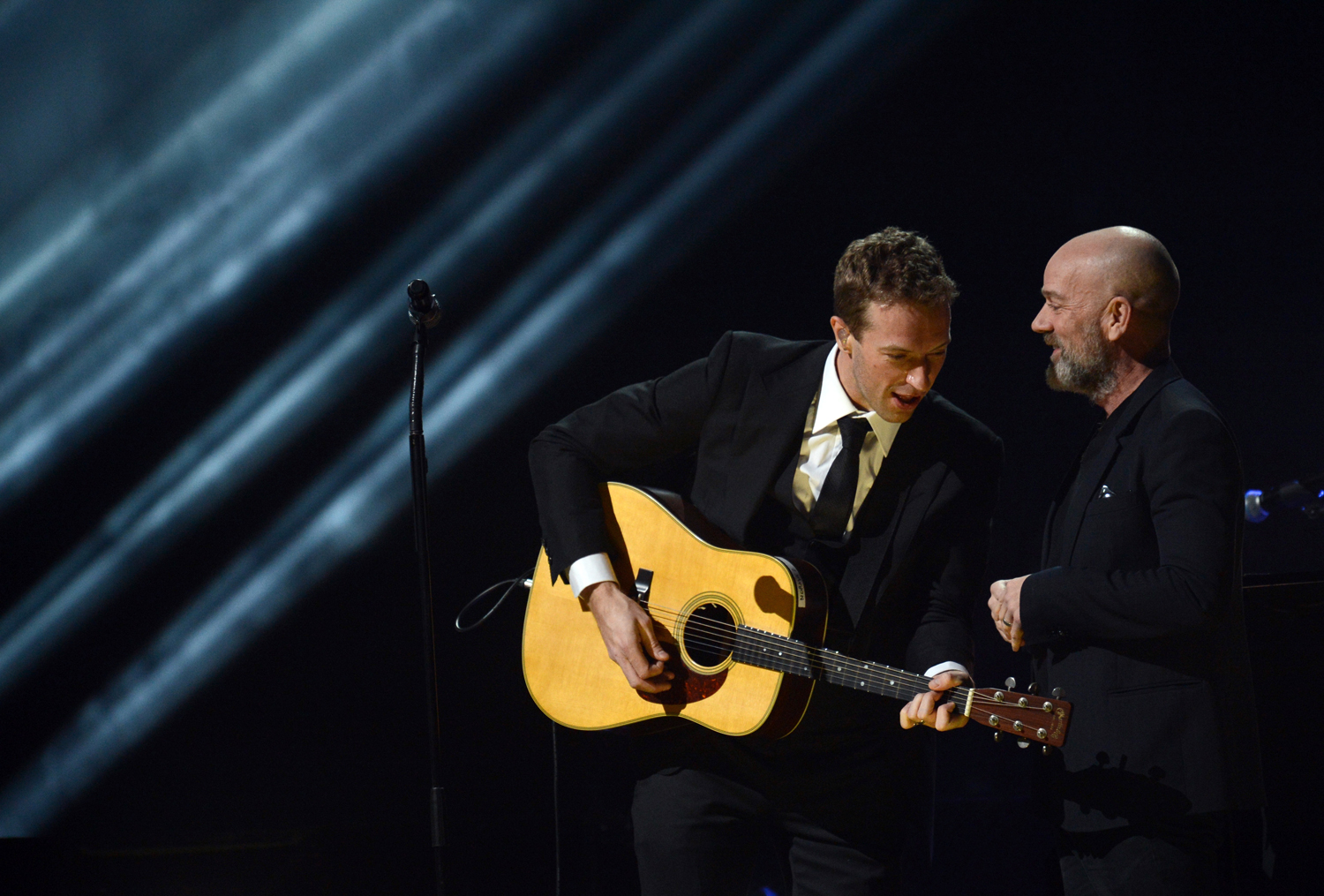 Chris Martin (L) performs with Michael Stipe