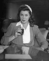 Esther Williams drinking a soda.