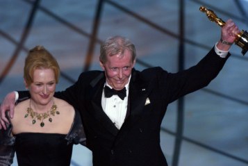 Actor Peter O'Toole holds up the honorary Oscar he was honored with by the Academy of Motion Picture Arts and Sciences as he embraces Meryl Streep, who presented it to him, during the 75th annual Academy Awards March 23, 2003, in Los Angeles. 