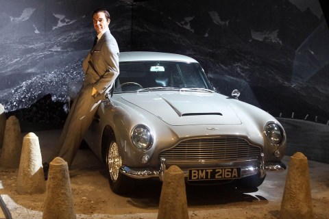 A waxwork of Sean Connery posing with an Aston Martin DB5 from 'Goldfinger' (1964)