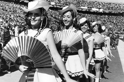 Girls from Tyler, Texas take the field with twirling fans and fancy formations for halftime of Super Bowl VI, which was played in New Orleans, La., on Jan. 16, 1972.