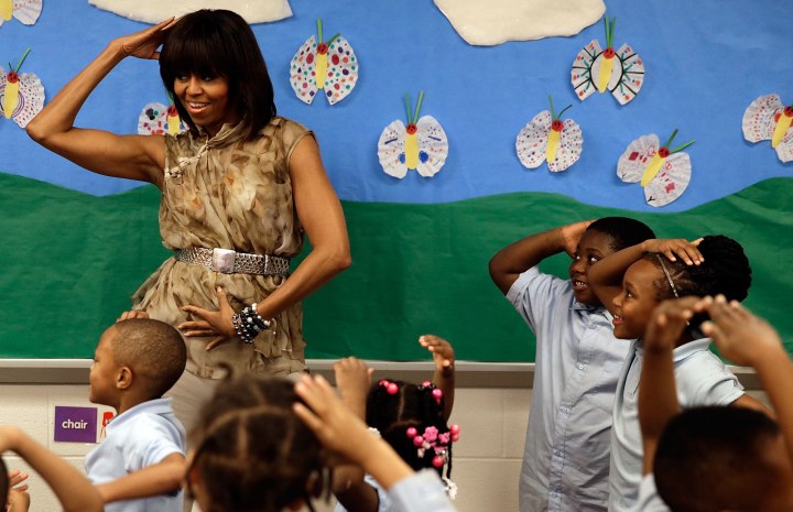 U.S. first lady Michelle Obama dances with pre-kindergarten students at the Savoy School in Washington, D.C., on May 24, 2013.