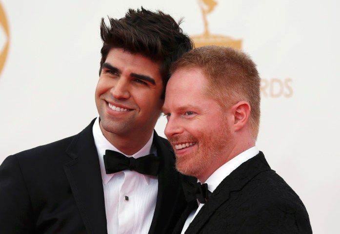 Actor Jesse Tyler Ferguson (R) from the ABC sitcom "Modern Family" poses with his husband Justin Mikita as they arrive at the 65th Primetime Emmy Awards in Los Angeles