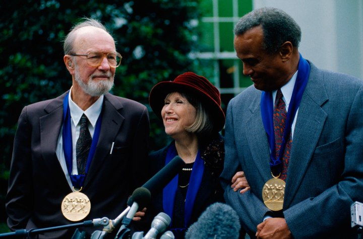 From left: Pete Seeger, actress Julie Harris, and actor Harry Belafonte speak at a press conference after being awarded the National Medal of Arts by President Clinton in Washington, D.C., on Oct. 14, 1994.