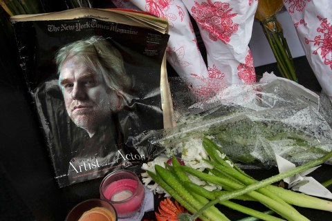 A copy of a New York Times Magazine with a photo of movie actor Philip Seymour Hoffman on the cover is pictured as part of a makeshift memorial in front of his apartment building in New York
