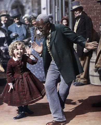 Photo f From left: Shirley Temple dances with Billy 'Bojangles' ROBINSON on the set of TK, in 1935.