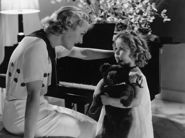 From left: Carole Lombard talks to Shirley Temple in a scene from the film 'Now And Forever', directed by Henry Hathaway for Paramount Studios, in 1934.