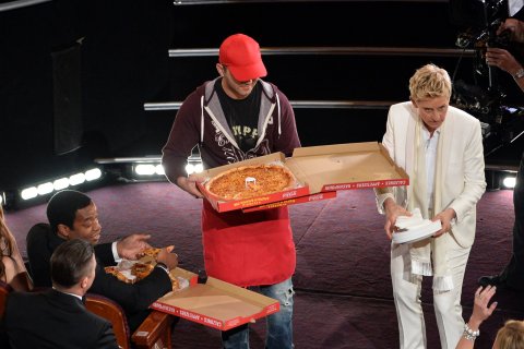 Host Ellen DeGeneres (right) and actor Chiwetel Ejiofor (far left) with pizza delivery man in the audience during the Oscars at the Dolby Theatre on March 2, 2014 in Hollywood.